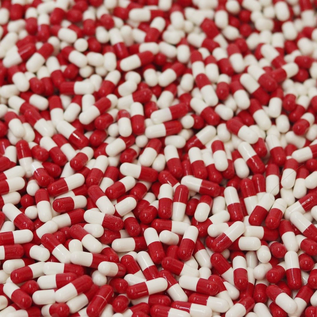 red and white medication capsule lot